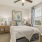 a bedroom with a bed and a lamp
