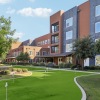 putting course in a courtyard with a building in the background