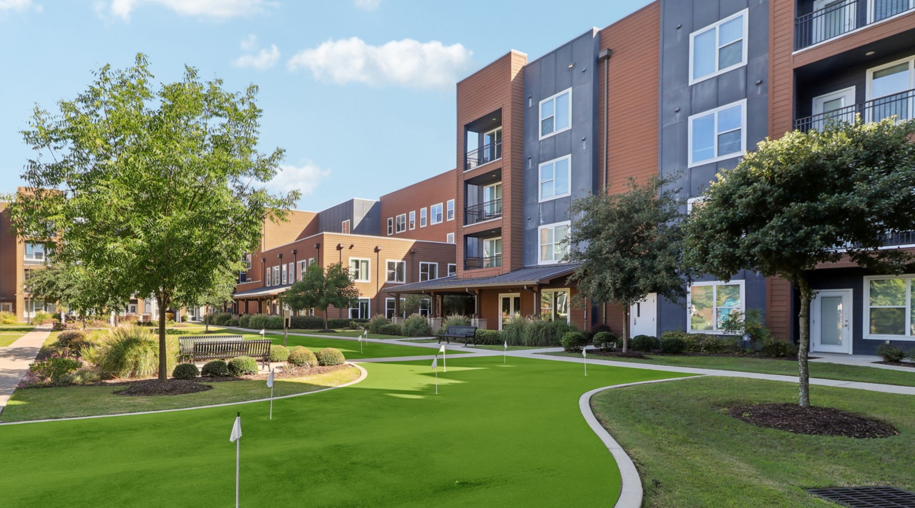 putting course in a courtyard with a building in the background