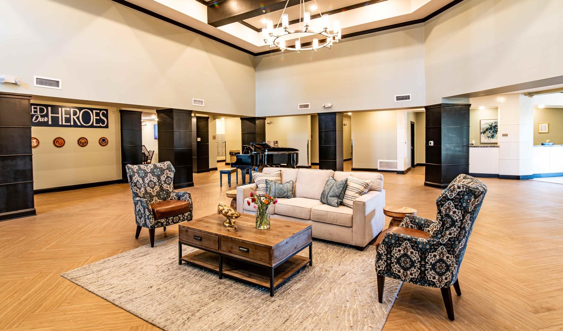 a large living room with a couch and chairs